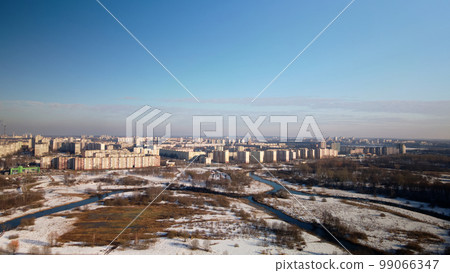 City park in winter. Snow lies on the ground. A meandering river flows. Aerial photography. 99066347