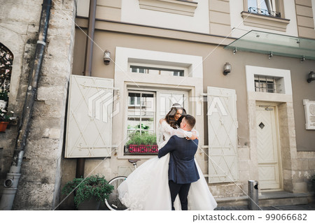 Romantic wedding moment, couple of newlyweds smiling portrait, bride and groom hugging Romantic wedding moment, couple of newlyweds smiling portrait, bride and groom hugging 99066682