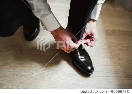 Beautiful man, groom posing and preparing for wedding 99066728