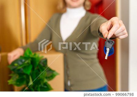 Starting new life. Overjoyed woman hold keys from new apartment or home. new life starts now 99066798