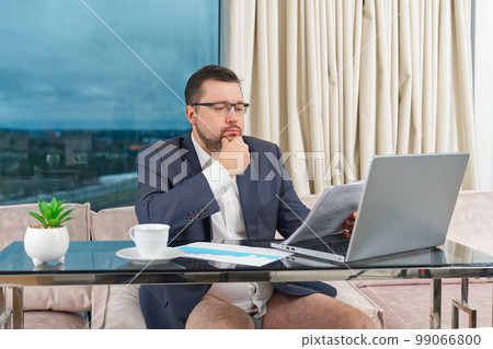 Man in suit without pants working online. home office, video conference, self-isolation concept Man in suit without pants working online. home office, video conference, self-isolation concept 99066800