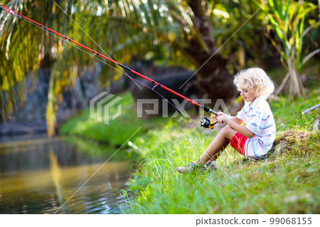 Boy fishing. Child with rod catching fish in river Boy fishing. Child with rod catching fish in river 99068155