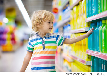 Child in supermarket. Kid grocery shopping. 99068162