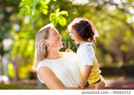 Mother and son in sunny park. 99068252