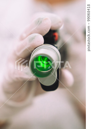 Close up shot of gloved hand with the laser hair removal machine's handpiece. Alexandrite laser techhnology removing hair. Close up shot of gloved hand with the laser hair removal machine's handpiece. Alexandrite laser techhnology removing hair. 99068418