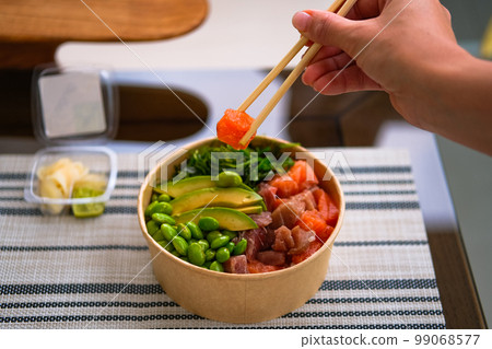 Frash raw appetizing poke bowl with salmon, avocado, rice. Frash raw appetizing poke bowl with salmon, avocado, rice. 99068577