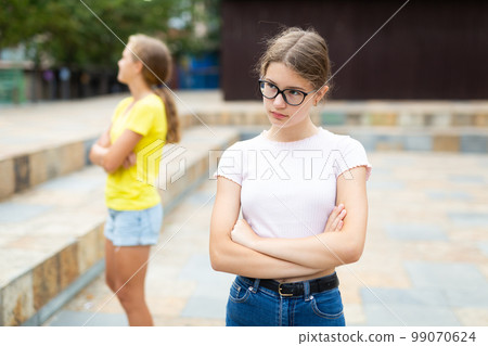 Offended girl turned away from her friend after quarrel on street Offended girl turned away from her friend after quarrel on street 99070624