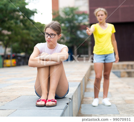 Two girlfriends after quarrel do not want to talk to each other 99070931