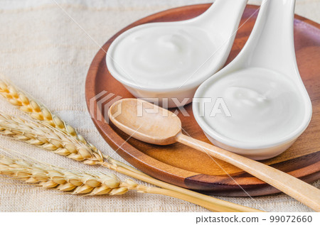 The Greek yogurt in a bowl and dry barley on tablecloth. The Greek yogurt in a bowl and dry barley on tablecloth. 99072660
