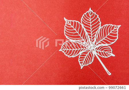 Carve of white paper leaves on a red colour cardboard background. Carve of white paper leaves on a red colour cardboard background. 99072661