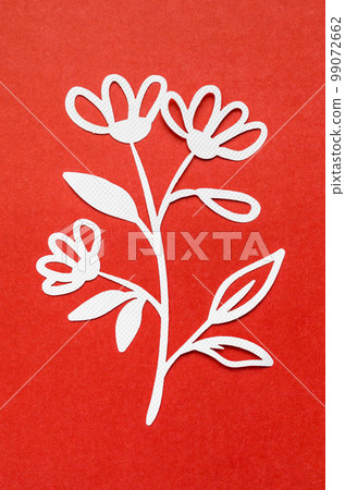 The Carve of white paper flower on a red cardboard background. The Carve of white paper flower on a red cardboard background. 99072662