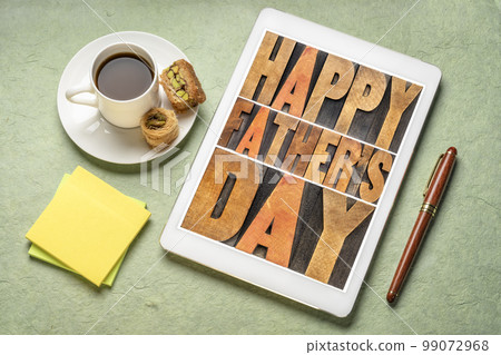 happy father's day - a word abstract in vintage letterpress wood type on a digital tablet with a cup of coffee, greeting card 99072968