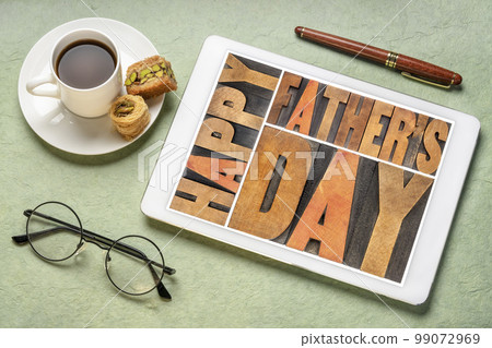 happy father's day - a word abstract in vintage letterpress wood type on a digital tablet with a cup of coffee, greeting card 99072969