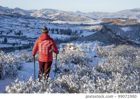male hiker in winter scenery of Rocky Mountains foothills in northern Colorado, Lory State Park 99072980