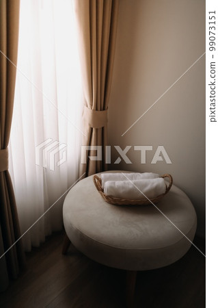 Neatly rolled small towels in the basket of a hotel room. Neatly rolled small towels in the basket of a hotel room. 99073151
