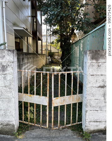 rusty gate and alley rusty gate and alley 99075426