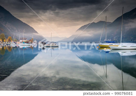 Sailboats on Achensee lake near Innsbruck at peaceful dawn, Tyrol alps, Austria Sailboats on Achensee lake near Innsbruck at peaceful dawn, Tyrol alps, Austria 99076081