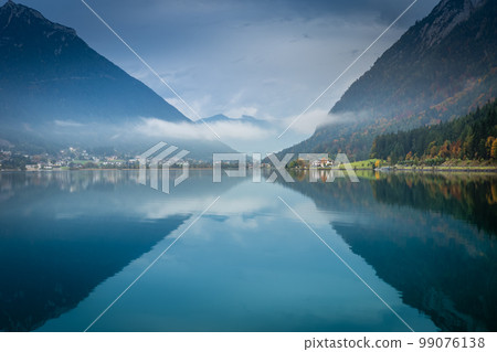 Sailboats on Achensee lake near Innsbruck at peaceful dawn, Tyrol alps, Austria Sailboats on Achensee lake near Innsbruck at peaceful dawn, Tyrol alps, Austria 99076138