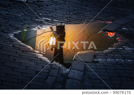 Vilnius old town, puddle reflection illuminated at night, Lithuania, Baltics Vilnius old town, puddle reflection illuminated at night, Lithuania, Baltics 99076178