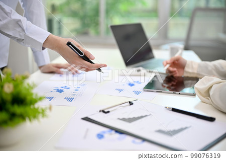 Businesspeople analyzing financial data, working on report, planning new financial strategy 99076319