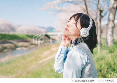 High school students listening to music under the cherry tree High school students listening to music under the cherry tree 99076699