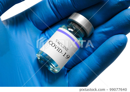 Doctor's hand holds bottle blue vaccine at the hospital. Health and medical concepts. Doctor's hand holds bottle blue vaccine at the hospital. Health and medical concepts. 99077640