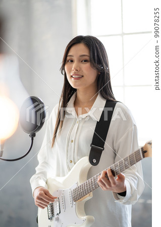 Young woman portrait (electric guitar, vocal) Young woman portrait (electric guitar, vocal) 99078255
