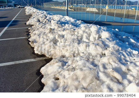 停車場角落裡堆積了一堆雪 99078404