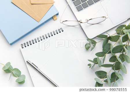 Modern white office desk table with laptop, notebook and other supplies. Modern white office desk table with laptop, notebook and other supplies. 99078555