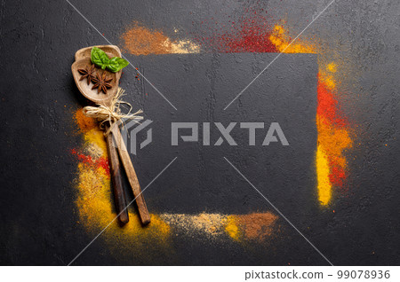 Various spices on stone table 99078936