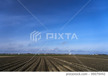 The plains of Konan on a winter day and the Hira mountain range in the snow The plains of Konan on a winter day and the Hira mountain range in the snow 99079442