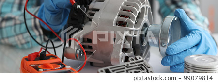 Automotive alternator repair test stator closeup with copper coil in workshop Automotive alternator repair test stator closeup with copper coil in workshop 99079814