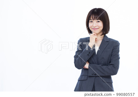 A business woman in her thirties thinking with a smile A business woman in her thirties thinking with a smile 99080557