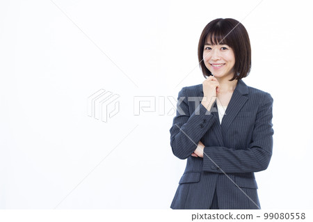 A business woman in her thirties thinking with a smile A business woman in her thirties thinking with a smile 99080558