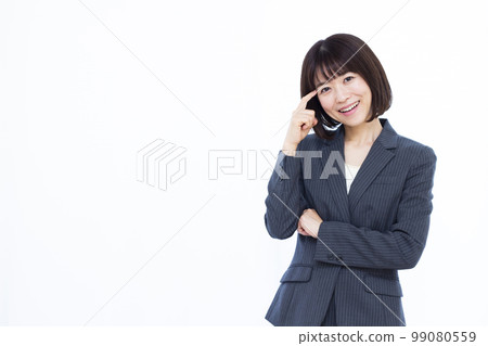 A business woman in her thirties thinking with a smile A business woman in her thirties thinking with a smile 99080559