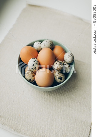 Easter eggs in the plate on beige background. Chicken and quail eggs 99082005