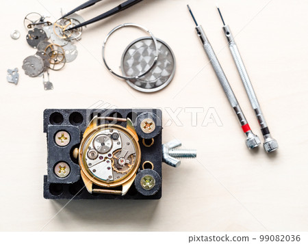 top view of open watch in holder on wooden table top view of open watch in holder on wooden table 99082036
