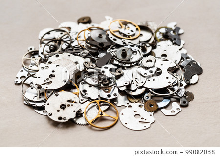 pile of spare-parts for mechanical clocks closeup 99082038