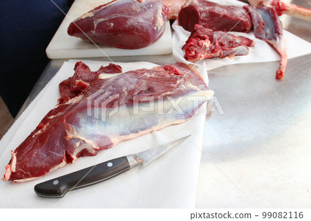 Wild game venison A photo of a knife and chunks of meat that have been cut 99082116