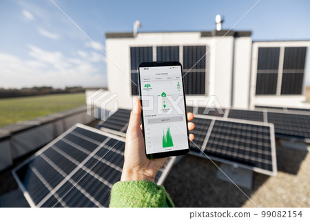 Woman monitors energy production from the solar power plant with a digital tablet Woman monitors energy production from the solar power plant with a digital tablet 99082154
