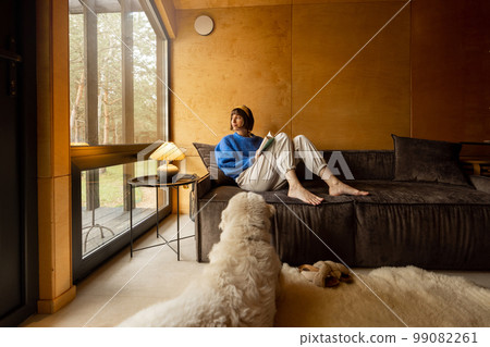 Woman with her dog in house on nature 99082261