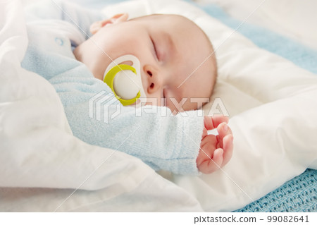 Cute three month old baby sleeping in comfortable bed. 99082641