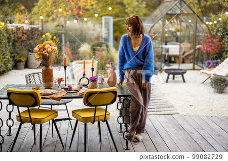Woman near decorated table at backyard 99082729