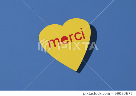 heart-shaped sign reads thank you in french 99083675