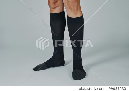 man wearing a pair of black compression socks man wearing a pair of black compression socks 99083680