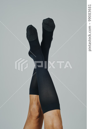 upside down man wearing compression socks 99083681