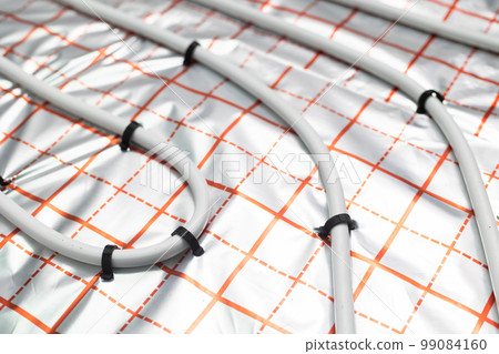 Detail of pipeline water heating system and underfloor heating system on the new residential house, concept of heated floor Detail of pipeline water heating system and underfloor heating system on the new residential house, concept of heated floor 99084160