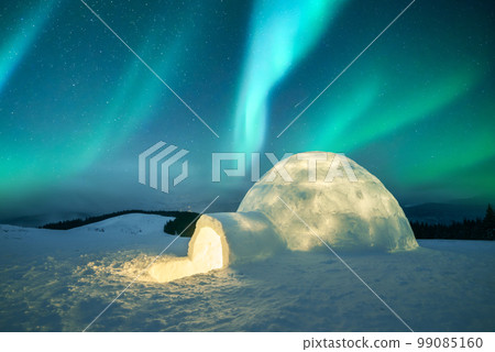 Wintry scene with glowing polar lights and snowy igloo 99085160