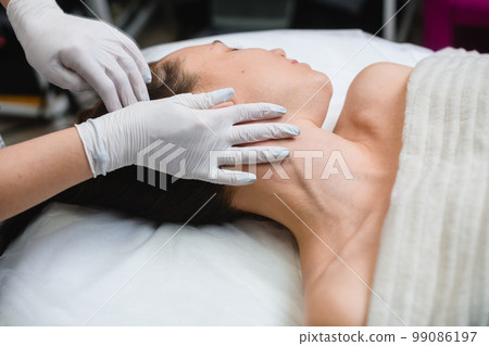 Cosmetology massage of neckline in beauty salon Cosmetology massage of neckline in beauty salon 99086197