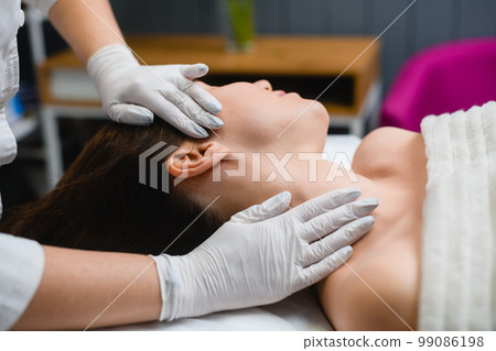 Cosmetology massage of neckline in beauty salon Cosmetology massage of neckline in beauty salon 99086198